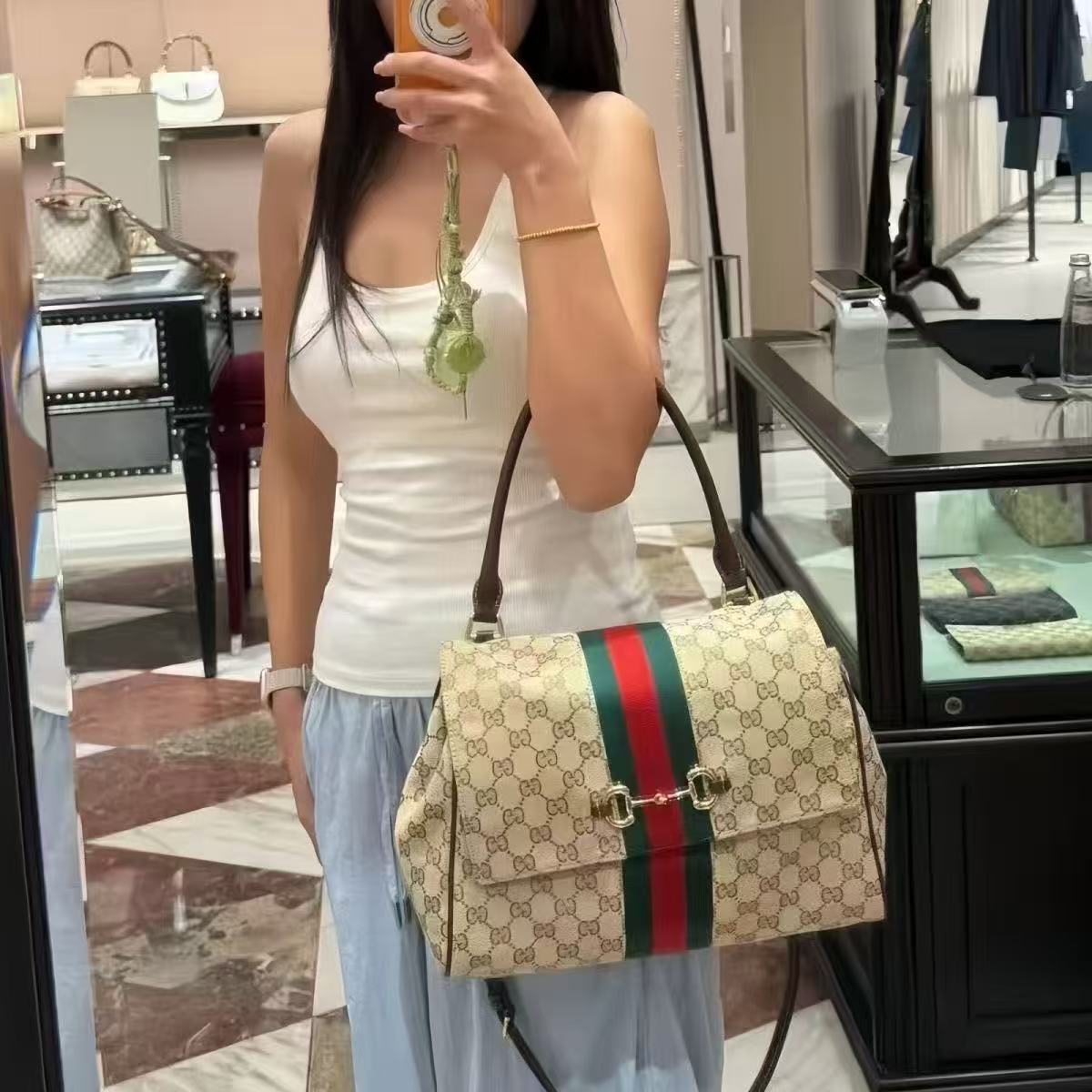 Beige patterned tote styled in hand