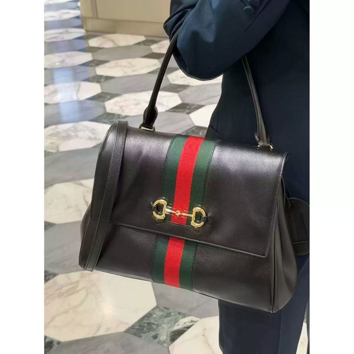 Black tote styled in hand
