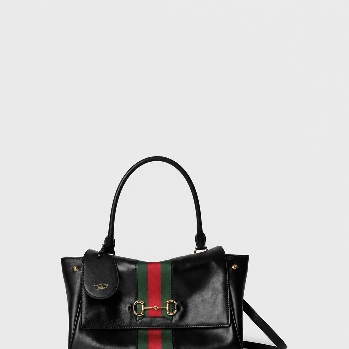 Black leather top-handle tote on a light grey background